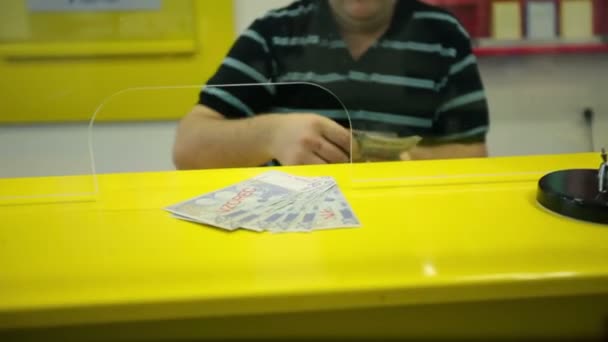 Close up on man in bank counting money — Stock Video