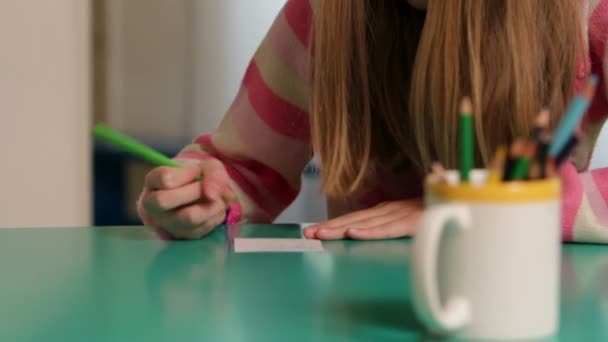 Serious young girl while drawing on paper — Stock Video