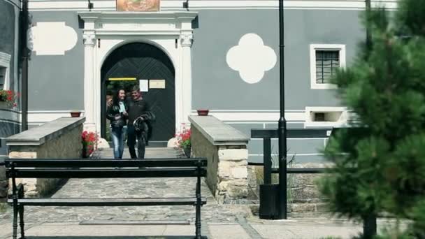 Tourists leaving the monastery shot from in front — Stockvideo