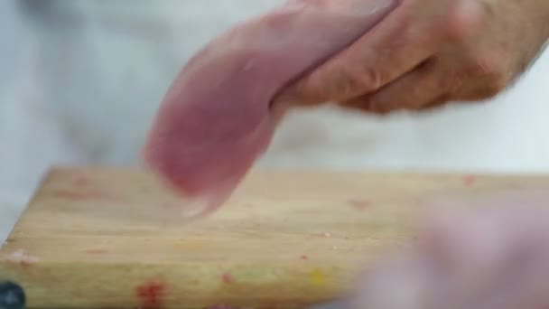 Cook cleaning turkey steak and slicing in half — Stock Video