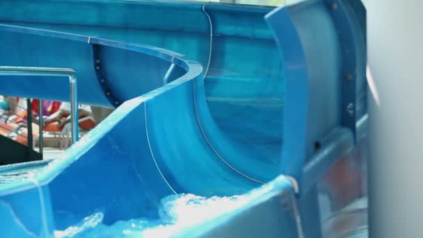 Close up on waterslide while group of kids sliding down — Stock Video