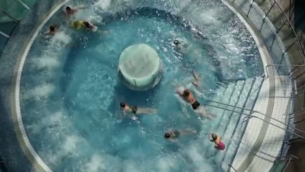 High angle shot of young kids jumping into pool — Stock Video