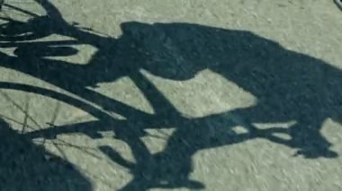 yarı yakın atış bisikletçi gölge beton yol üzerinde