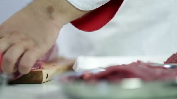 Cook arrainging cuts of red meat on aluminum plate — Stock Video