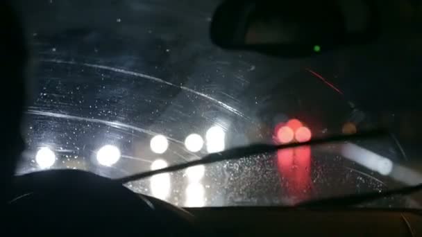 Car wipers are removing rain at slow nightdrive throught the city — Stock Video