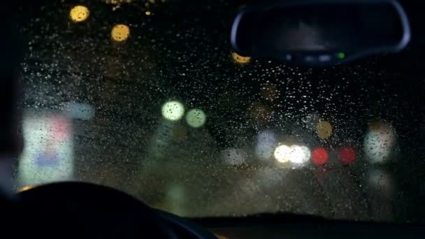 Unfocused nightdrive shot of wipers removing rain — Stock Video