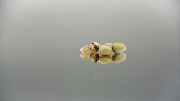 Pan shot of a couple of pistachios in slow motion — Stock Video