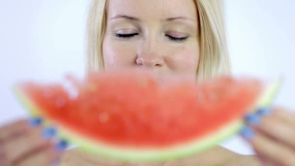 Woman taking bite from fresh watermelon slice — Stock Video