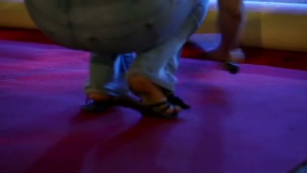 Mujer está limpiando la alfombra roja en cuclillas en sus pantalones vaqueros — Vídeo de stock