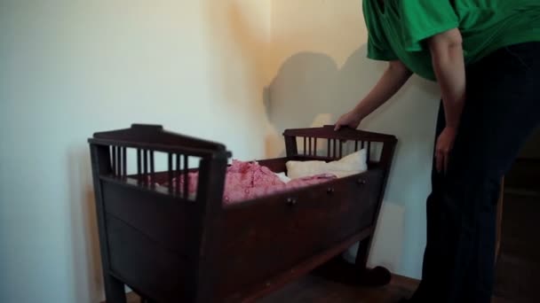 Woman is rocking her kid in a cradle — Stock Video