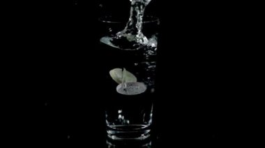 Vitamin tabletleri bir bardak su düşmek ve çözülmeye başlar