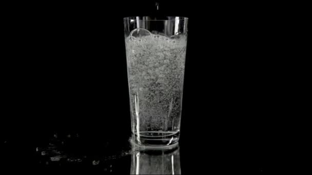 Pouring some more fizzy water into the glass — Stock Video