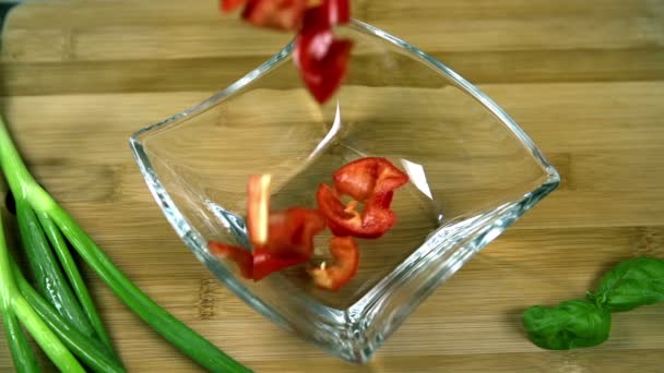 Top-view shot of sliced pepper falling into glass cup — Stock Video