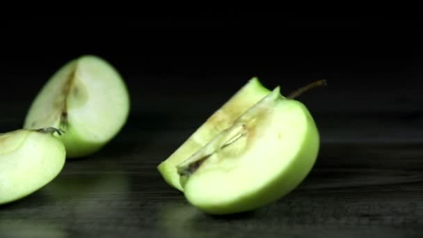 Pieces of green apple wobble around in slow motion — Stock Video