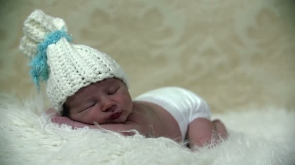 Baby boy with white cap sleeping firmly — Stock Video