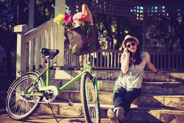 Beautiful woman with bicycle — Stock Photo, Image