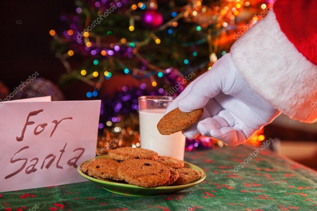 Santa Claus taking milk and cookies Stock Photo by ©Dangubic 26374419