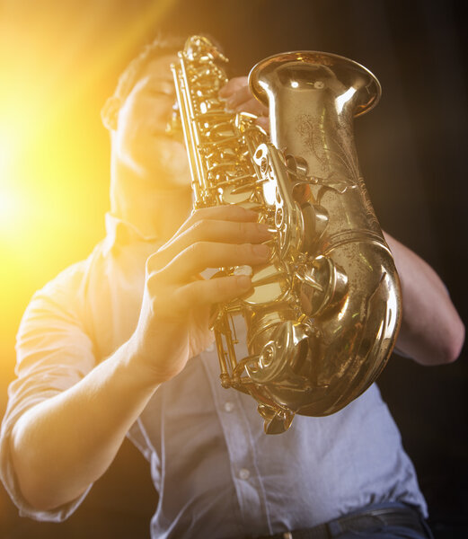 Young man playing the Saxophone.
