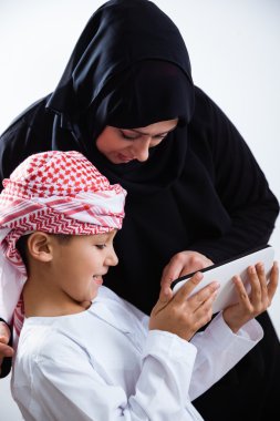 Arabic woman and son using tablet clipart