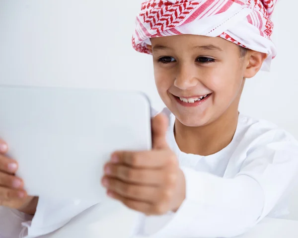 Arabic boy playing on tablet — Stock Photo, Image