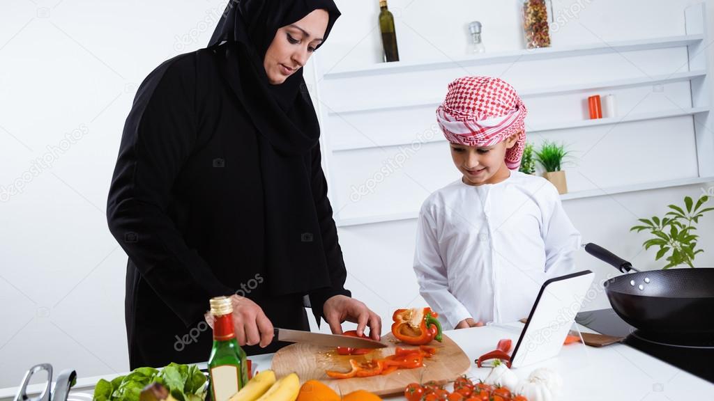 Arabic child in kitchen with mother