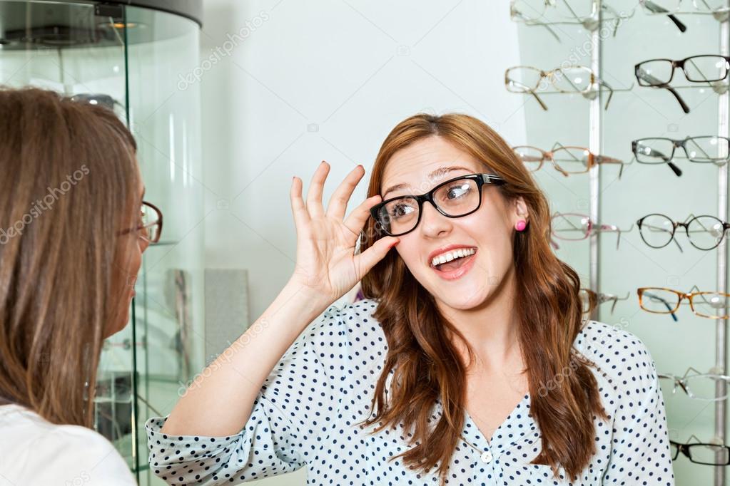 Woman With Friend Examining Eyeglasses