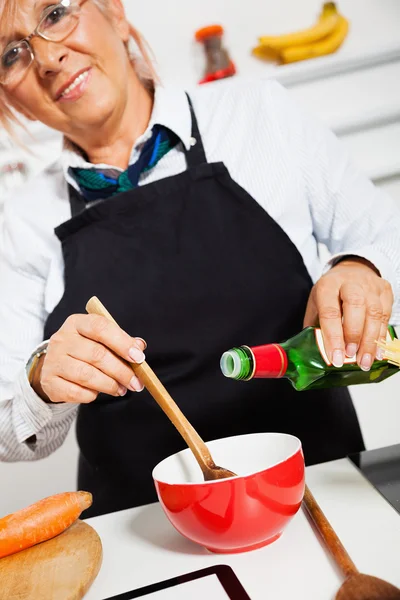 Bonne femme cuisine dans la cuisine — Photo