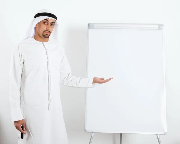 Middle Eastern businessman next to board — Stock Photo, Image