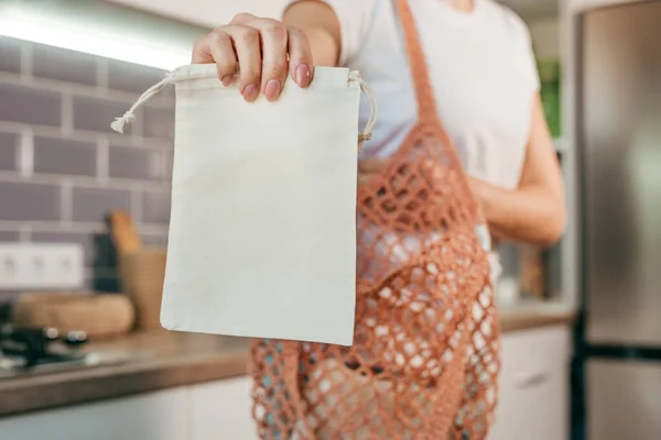 Closeup Young Woman Holding Reusable Cotton Produce Bag Putting Shopper — стоковое фото