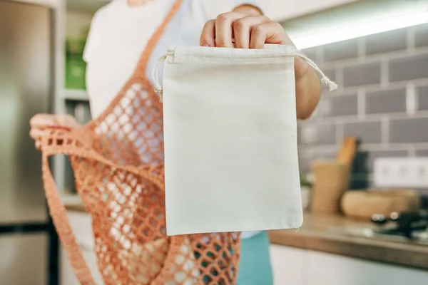 Closeup Young Woman Holding Reusable Cotton Produce Bag Putting Shopper — стоковое фото