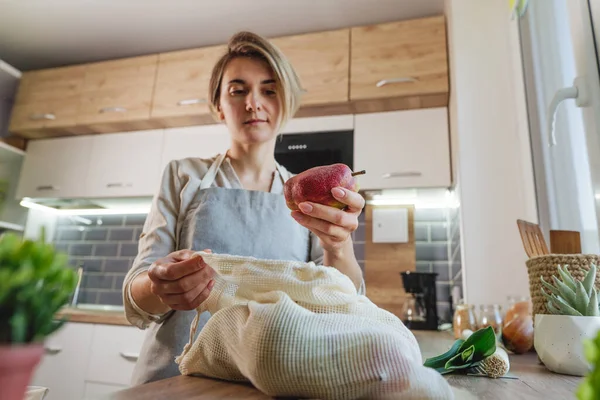 Young Woman Holding Organic Cotton Reusable Produce Bag Pears Table — стоковое фото