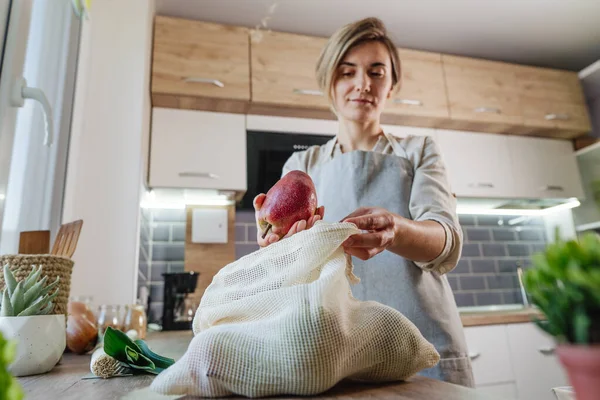 Young Woman Holding Organic Cotton Reusable Produce Bag Pears Table — стоковое фото