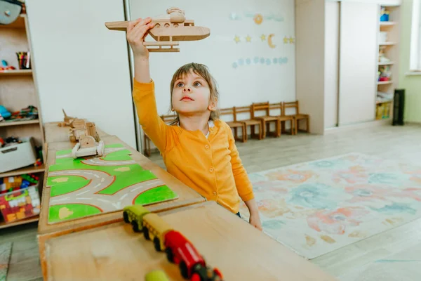 Little Girl Playing Wooden Plain Table Kindergarten Childcare Centre Montessori — Zdjęcie stockowe