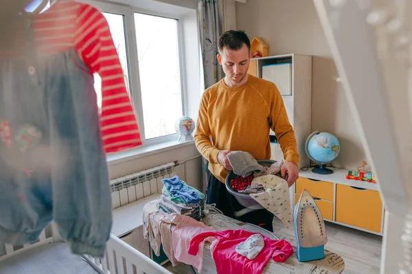Young Man Prepairing Clean Baby Clothes Ironing Children Room Father — Stock Fotó
