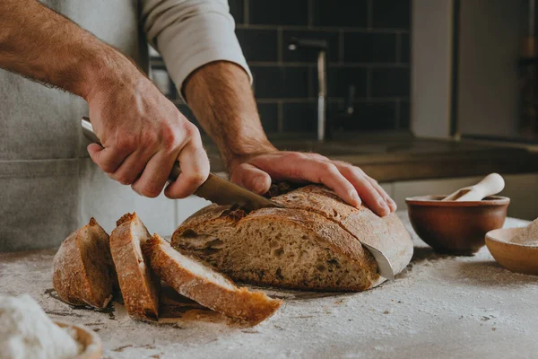 Unrecognizable Young Man Apron Cutting Homemade Whole Grain Bread Selective — Foto de Stock