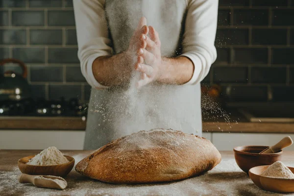 Unrecognizable Young Man Apron Making Bread Sprinkling Flour Wooden Table — Foto de Stock