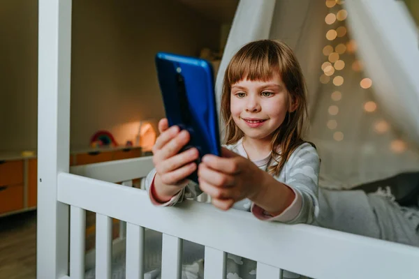 Little Girl Using Smartphone Sitting Bed Handmade House Generation Alpha —  Fotos de Stock