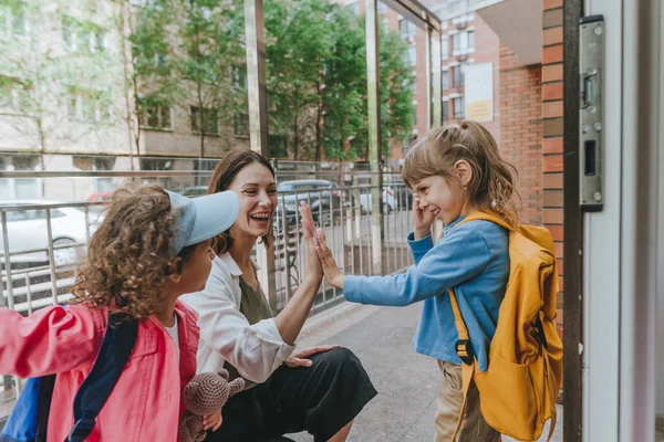Happy Smiling Woman Teacher Greeting Elementary School Students Giving High — Stockfoto