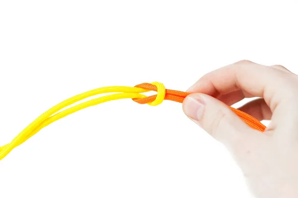 Węzeł z paracord, pomarańczowy i żółty przewód — Zdjęcie stockowe