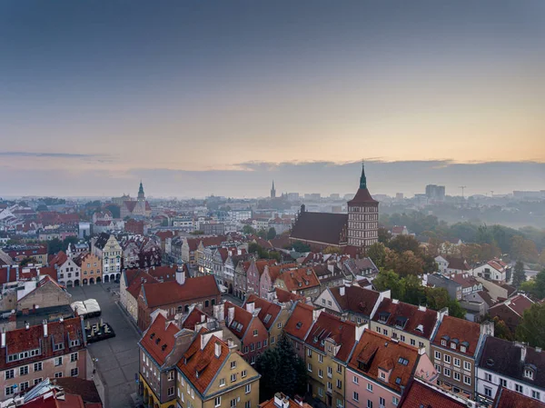 Olsztyn from a bird\'s eye view in the morning. City in Poland. Old Town in the fall. The old town houses are shrouded in fog. In the distance you can see the Cathedral Basilica, the Town Hall and the Church of the Sacred Heart of Jesus.