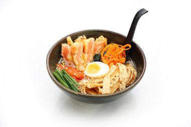 Miso ramen with salmon, egg, and noodles.Traditional Japanese ramen soup. Soup in a bowl, dish on a white background.
