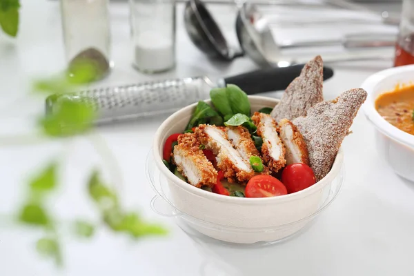 Salad with grilled chicken. Box diet. Appetizing lunch boxes. Food delivered to your home