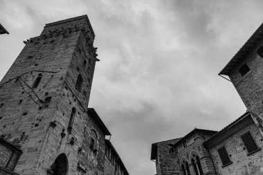 San Gimignano, Toskana 'da bir şehirdir. 13. yüzyıl duvarlarıyla çevrili olan tarihi merkezinin en önemli parçası Piazza della Cisterna 'dır. Ortaçağ kulelerinin siluetinde Torre Grossa taşın altında duruyor..