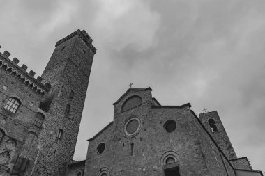 San Gimignano, Toskana 'da bir şehirdir. 13. yüzyıl duvarlarıyla çevrili olan tarihi merkezinin en önemli parçası Piazza della Cisterna 'dır. Ortaçağ kulelerinin siluetinde Torre Grossa taşın altında duruyor..