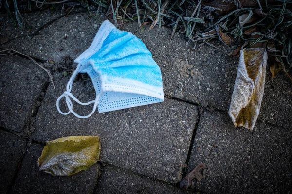 Uma Máscara Médica Descartada Coberta Com Geada — Fotografia de Stock