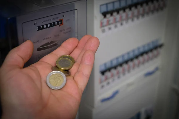 One Hand Several Euro Coins Front Three Phase Meter — Stockfoto