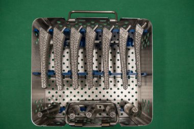 some surgical rasps for a transfemoral prosthesis lie in an instrument container