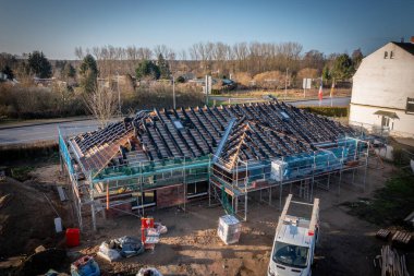 Yeni yapılmış bir evin çatısını fayanslarla kaplama sürecinde.