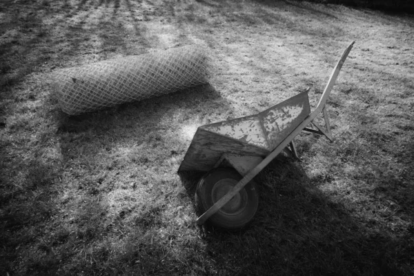 Wheelbarrow Lies Next Roll Wire Mesh Fence — Stock Photo, Image