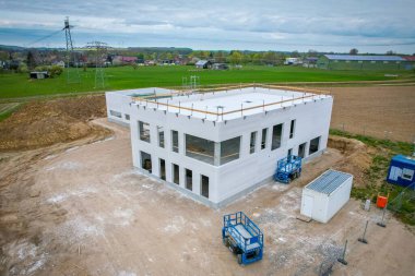 a drone image of a construction site on which a company building is being erected